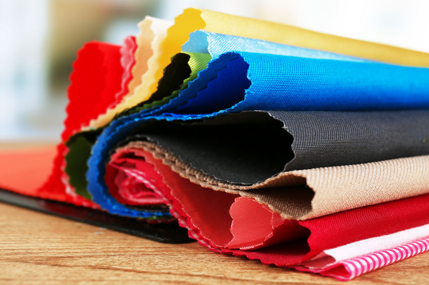 Colorful fabric samples on wooden table and light blurred background Tekstil